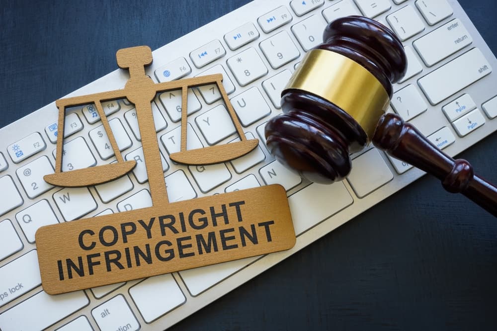 copyright infringement sign next to gavel on a keyboard