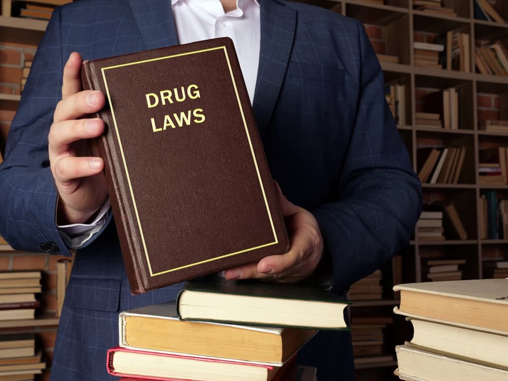 lawyer holding drug laws book