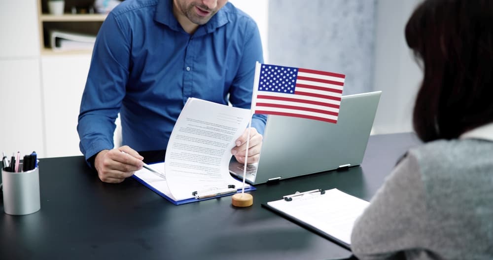 A person is undergoing the process of applying for US immigration and attending a consular visa interview.