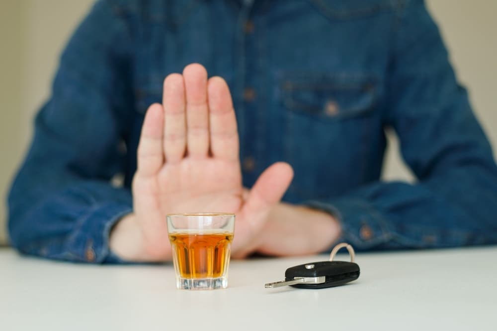 Man refusing drink while driving