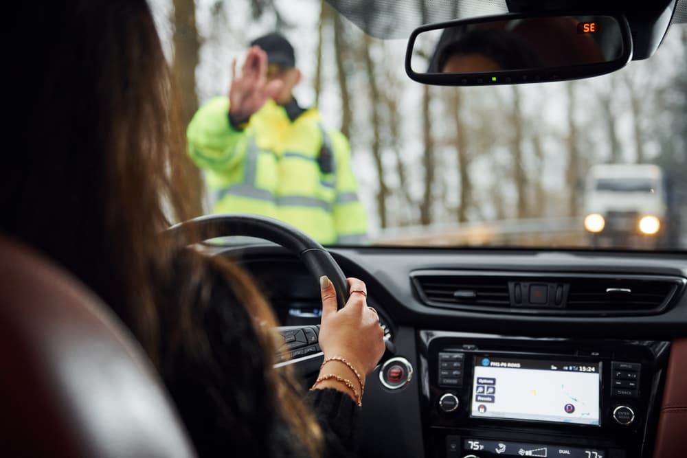 Woman in car followed by police officer