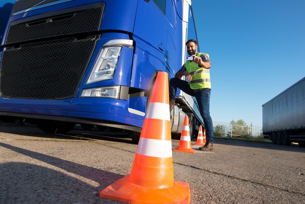 Truck driving school. A bearded man learns to drive a truck at a driving school. A truck driver candidate training for a driving license.